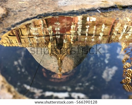 golden pagoda with blue sky reflection upside down in small water on ground broken travel the temple at Mandalay Myanmar amazing place for good memory