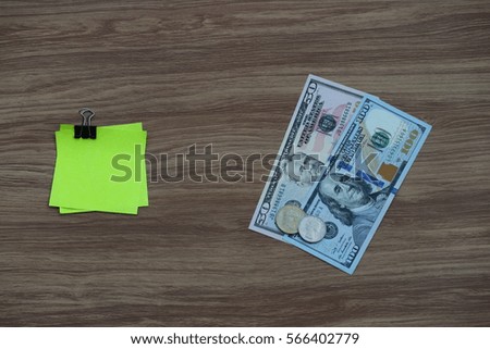Note paper with clip and dollar cash banknote and coin, business finance concept with copy space for text