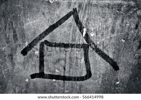 House drawn on the the rough wall with a paint brush. Concept of home.