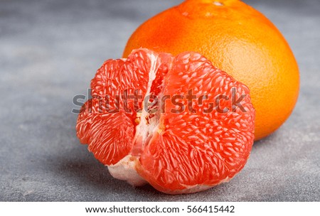 Juicy grapefruit close up on the gray stone table. Selective focus