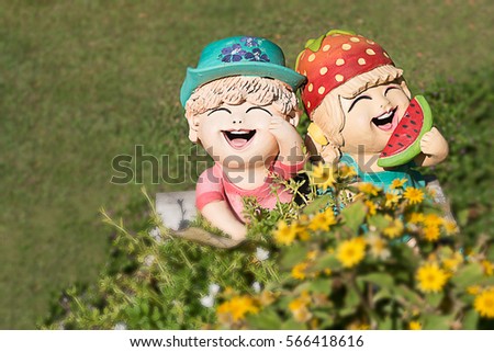 close up:Dolls, girl and boy who love laughing Clay sculpture in the garden <process color>