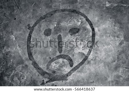 Abstract  face drawn on the rough wall with a paint brush.