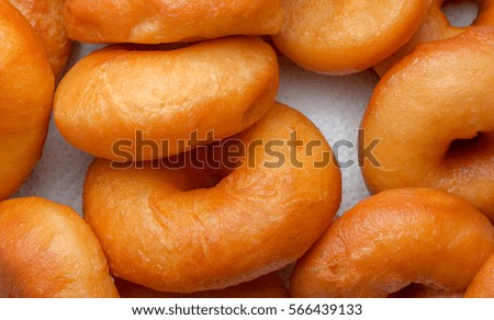 closeup of fresh brown donuts and no sugar.