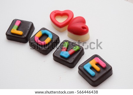Chocolates arranged in a heart shape, red for love and meaningful Valentine's Day.