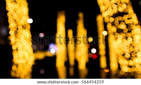 Abstract background of Yellow or gold lighting around trees. use shift focus blur technique , and silhouette people