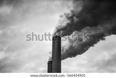 closer up view of smoking smokestacks in Black and White  Royalty-Free Stock Photo #566454901