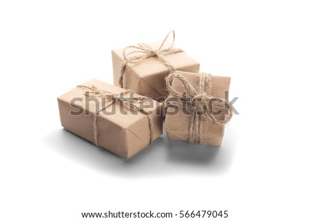 Boxes with gift wrapped in kraft paper on isolated white background