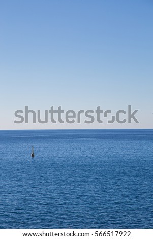 View of the coast of the Ligurian Sea with a marker buoy.
