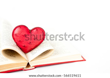 Red heart is in open pages of the book