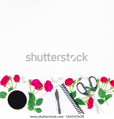 Frame with roses, notebook, pen, clips, scissors and coffee mug on white background. Flat lay, top view. Woman workspace.