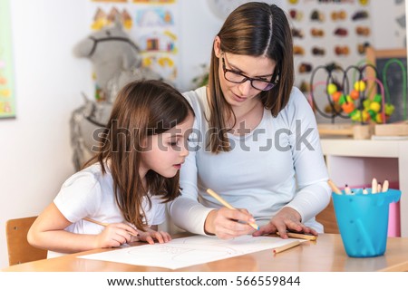 Teacher Mom working with Creative Kid Royalty-Free Stock Photo #566559844