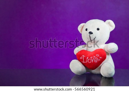 Teddy bear with heart sitting on the glass with  purple background. Get Taste Forever Valentine.