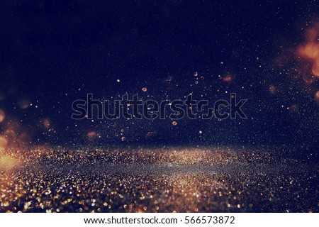 glitter vintage lights background. gold, blue and black. de-focused