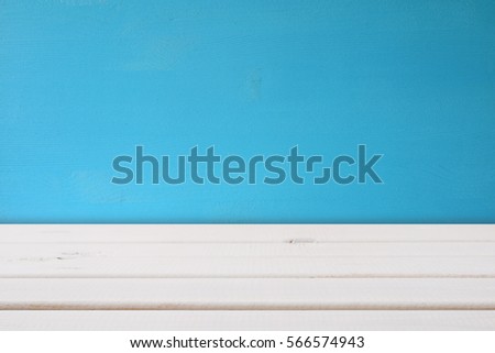 Empty table in front of blue wooden background. For product display montage