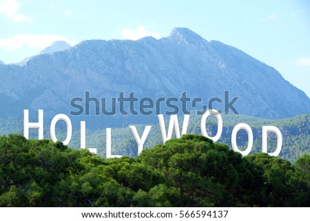 Word HOLLYWOOD on landscape background