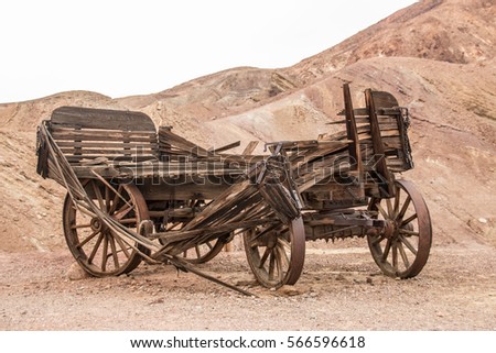 Old wooden broken wagon in calico ghost town, USA Royalty-Free Stock Photo #566596618