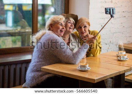 Selfie of ladies in cafe. Senior women smiling. Years pass but friends remain.