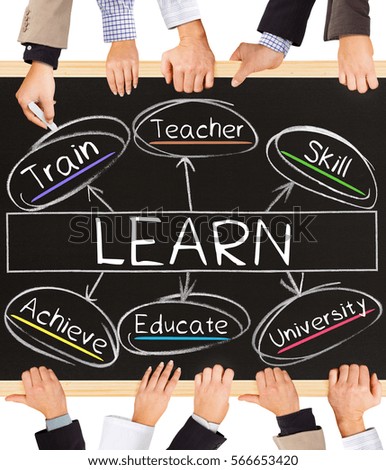 Photo of business hands holding blackboard and writing LEARN concept