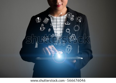 Woman hand holding tablet with business doodle icons on screen. Business technology concept.