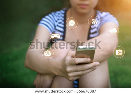 Focus hand of Young woman touching smartphone - Sunset filter effect and technology icon.