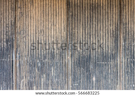 Old scratched metal wall. It is made of corrugated iron sheet. Royalty-Free Stock Photo #566683225