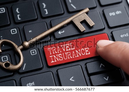 Closed up finger on keyboard with word TRAVEL INSURANCE