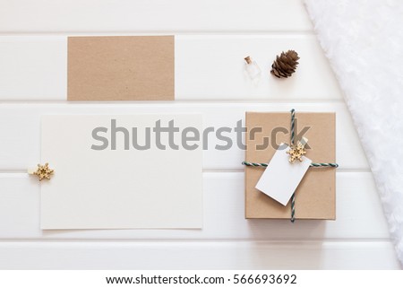 Mockup. Cards and a box for congratulations on a white wooden table and a white fur coat.