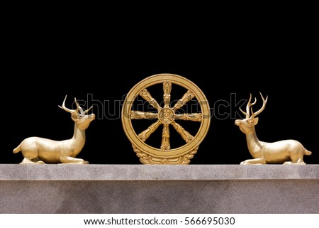Wheel of Dhamma and deer squat symbol in the Buddhist. The symbol of enlightenment and to Buddhism. Isolated on black with work paths