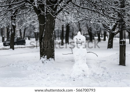 Snowman standing in winter forest