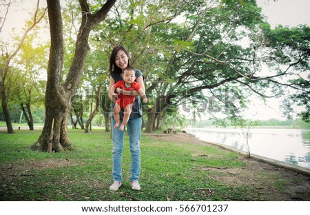 Portrait of happy loving mother and her baby outdoors,Beautiful young mother holds a baby