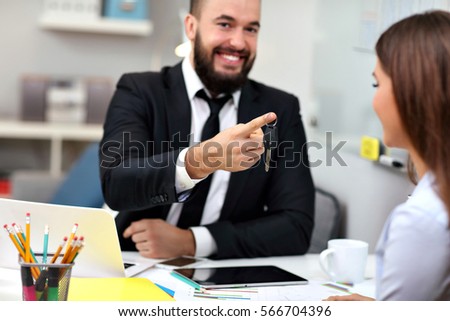 Picture showing businessman giving out car keys