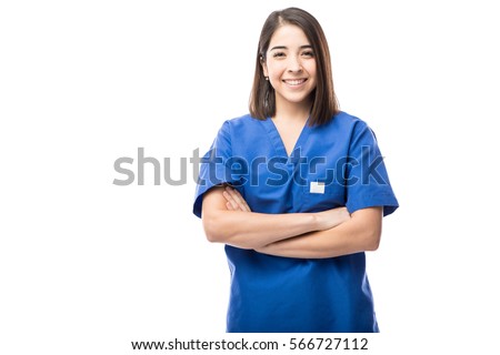Portrait of a good looking young nurse with her arms crossed in a white background