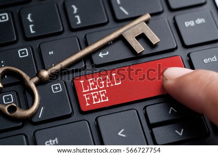 Closed up finger on keyboard with word LEGAL FEE