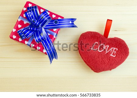 Fluffy heart and gift box on wooden table
