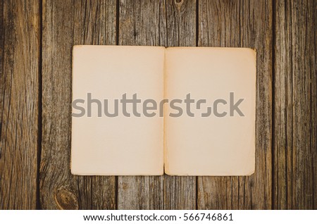 Vintage blank book top view on old wooden table background
