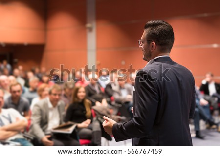 Speaker giving talk at business conference event. Audience at conference hall. Business and Entrepreneurship concept. Royalty-Free Stock Photo #566767459