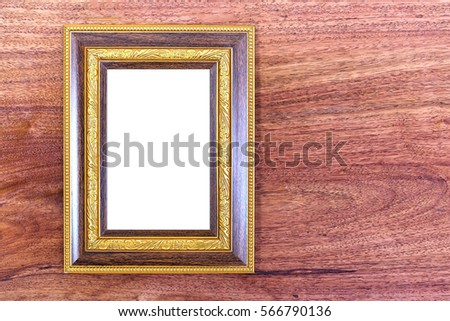 Gold photo frame on wooden background
