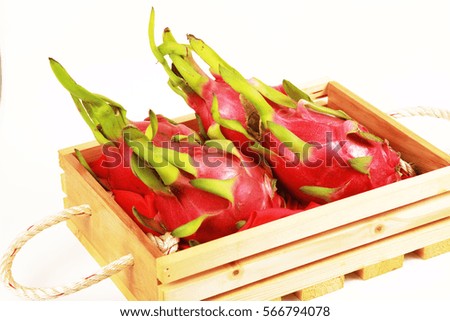 Dragon fruit on wood plate in white background.