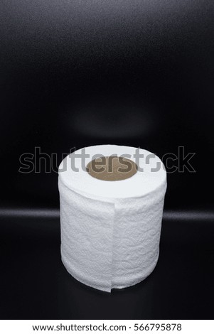 white tissue roll on black background.