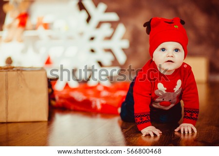 Cute little boy opening Christmas presents