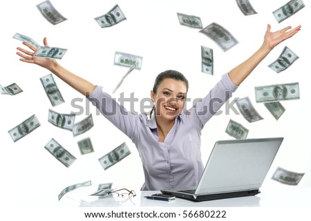 Happy brunette woman in glasses with lucky money - dollars coming down like rain. Photo of beautiful woman near laptop, isolated on white background 