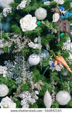 A closeup of a Christmas tree showing some decorations