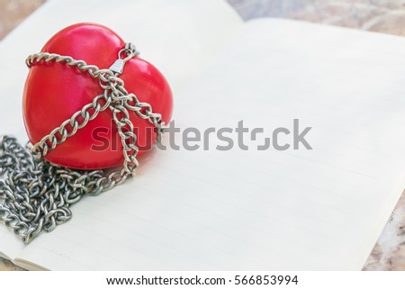 Red heart tied with chains, Valentine Concept.