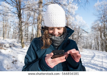 Outdoor girl take photos in winter nature