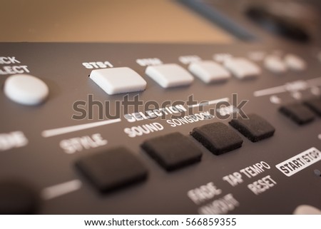 Selection button to control electronic musical keyboard