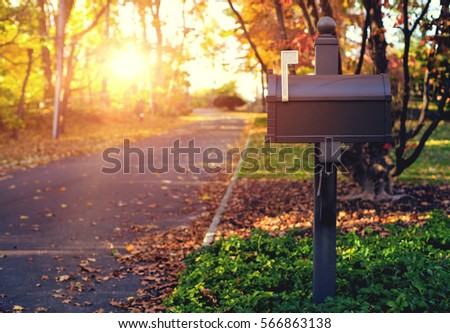 Mail Box in the autumn village. Sunset. Royalty-Free Stock Photo #566863138