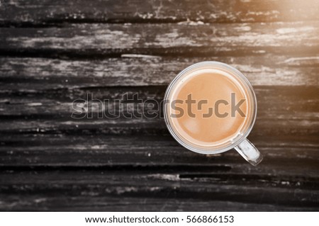  Top view of cup of hot coffee on log or timber background. copy sp