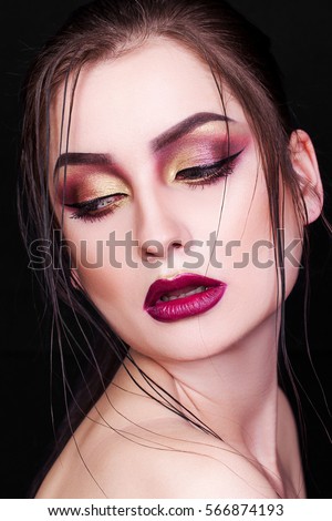 Beautiful woman with bright creative make-up on black background, looking away, bare shoulders, closeup, portrait, girl