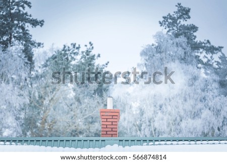 House chimney on roof in winter. Close up of roof with chimney.