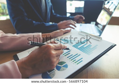 Business concept. Business people discussing the charts and graphs showing the results of their successful teamwork. Selective focus. Royalty-Free Stock Photo #566897104